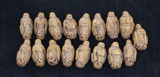 A collection of seventeen luohan peach stone beads, early 20th century.